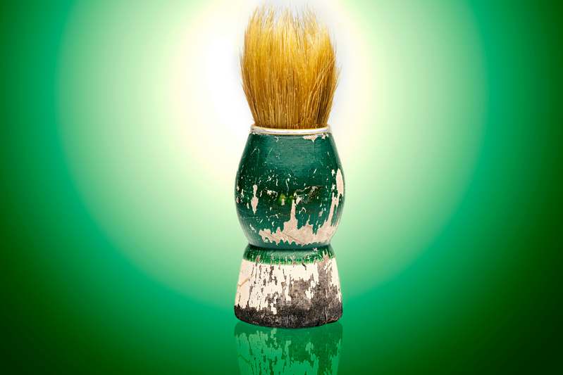 Artisan shaving soap in wooden bowl with brush creating creamy lather